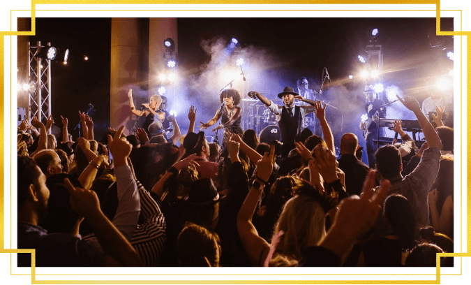 The band Liquid Blue playing on stage in front of a big dancing crowd
