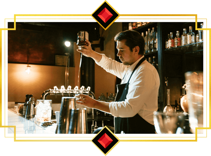 A man in a white shirt and black apron bartending