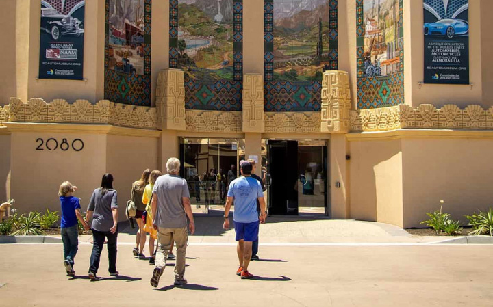 A family walking into the San Diego Automotive Museum in Balboa Park