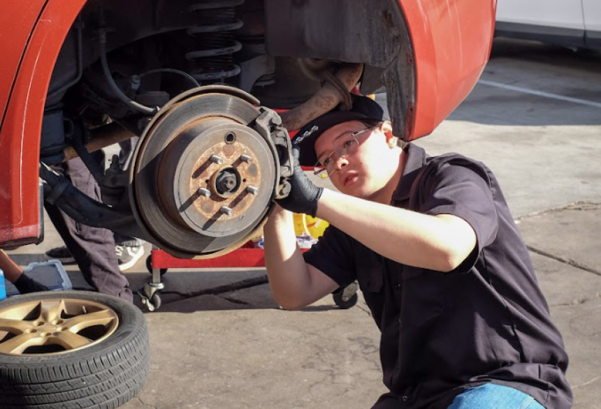 An IGNITE participant working on a car