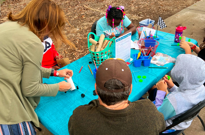 Students working on a hands-on activity during a school program at the San Diego Automotive Museum