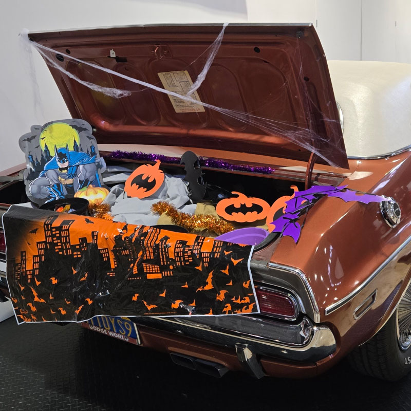A car trunk set up with Batman Halloween decorations and candy